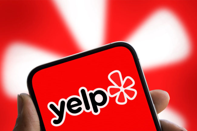 Yelp logo on cellphone. 